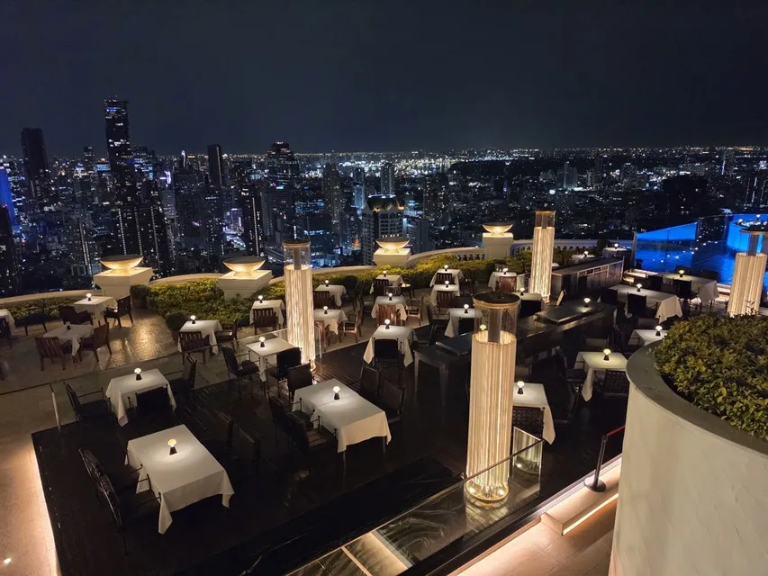 Rooftop tables at Sirocco by lebua with the Bangkok skyline at night