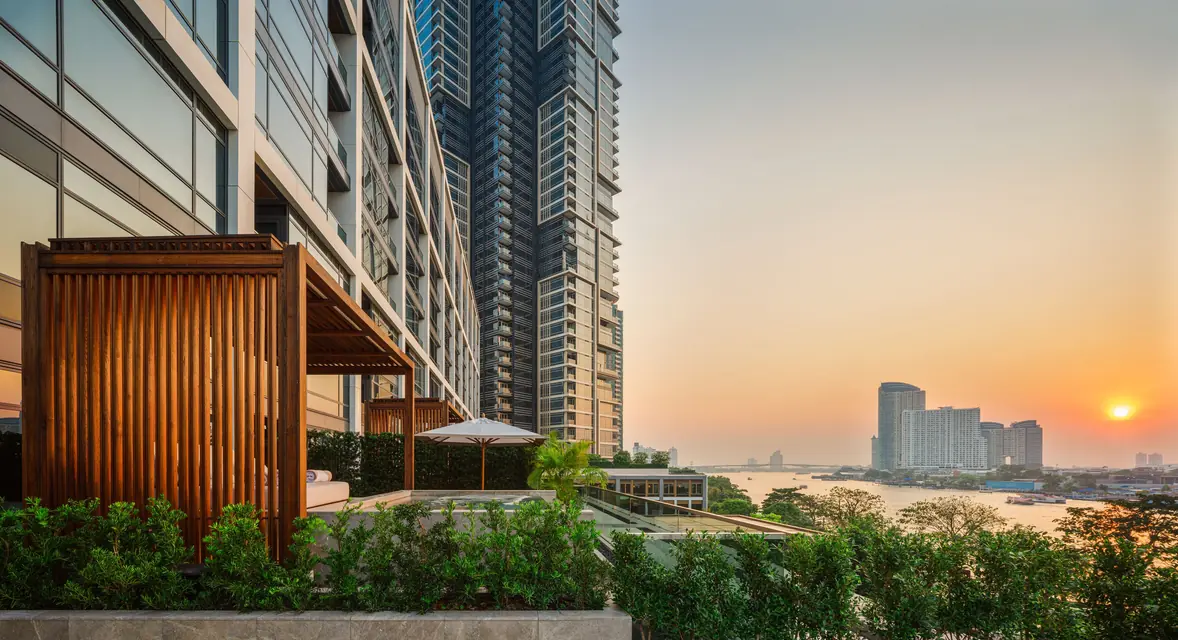 Capella Bangkok riverside garden at sunset